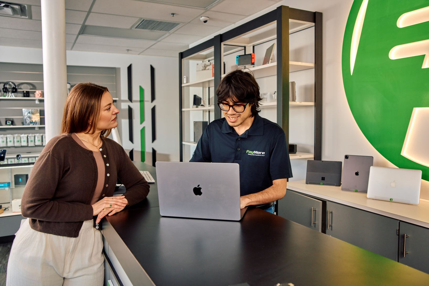 paymore employee inspecting a laptop